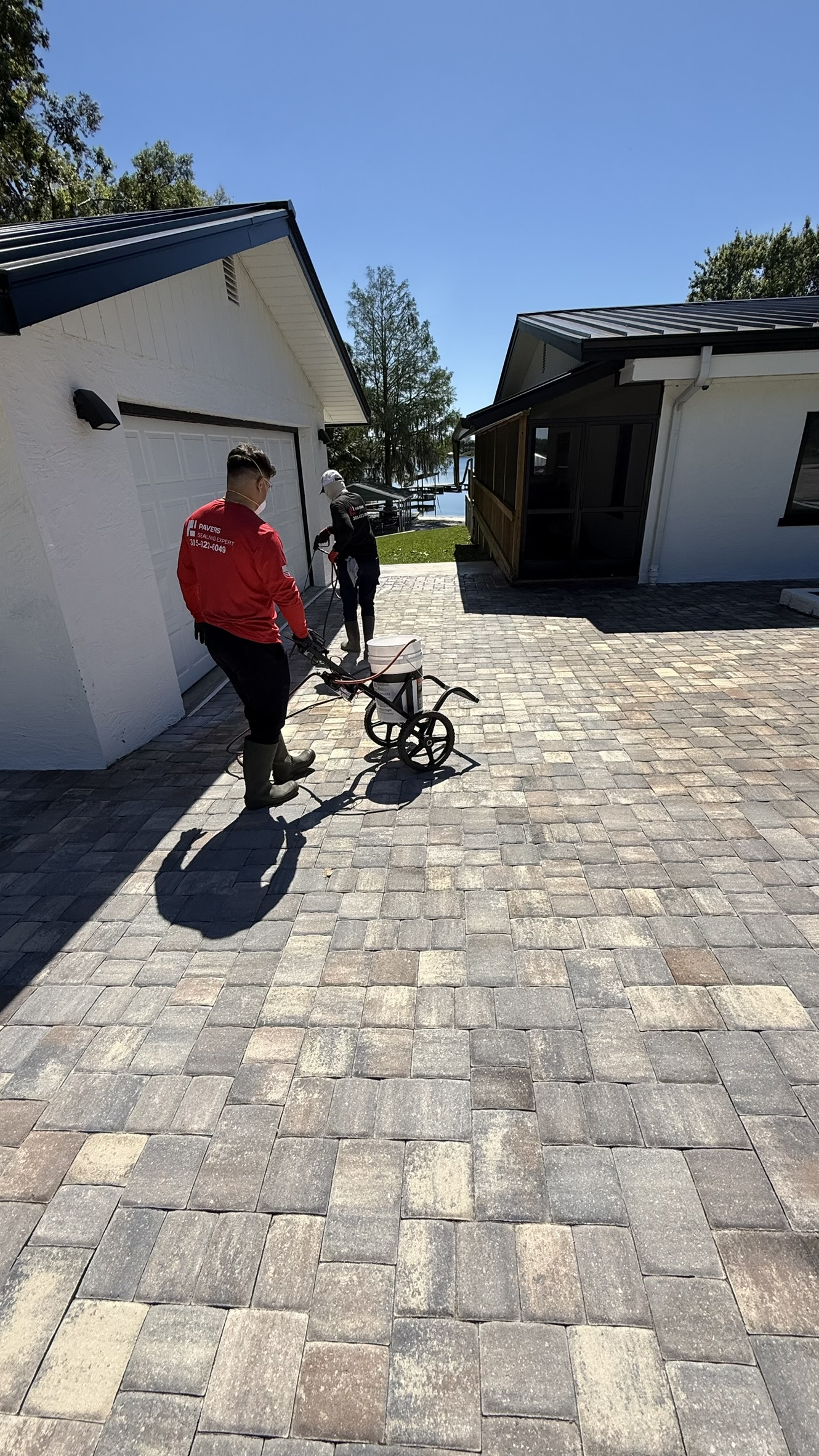 Freshly sealed gray paver driveway with a rich, even finish in Miami