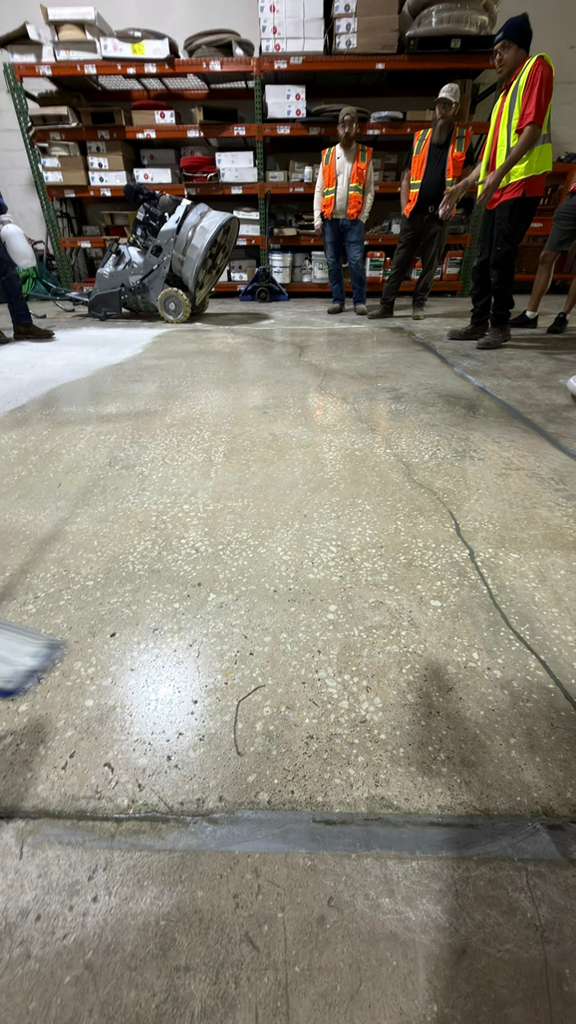 Polished concrete vs epoxy — crew grinding a concrete warehouse floor during the polishing process in Miami, Polished concrete entryway in Miami with high gloss finish.