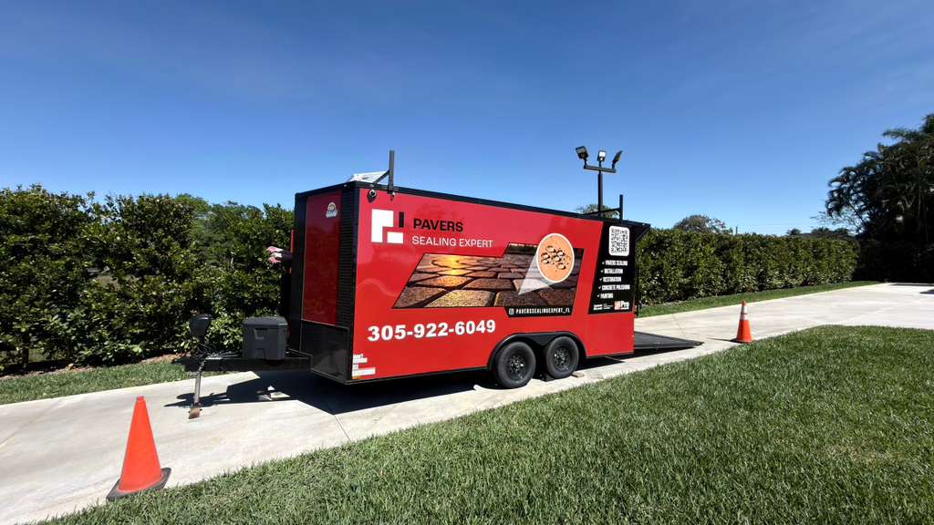 Paver Sealing in Homestead, FL, Side view of the Pavers Sealing Expert red service trailer at a residential job site in Miami, Florida, showcasing professional paver sealing, installation, and restoration services